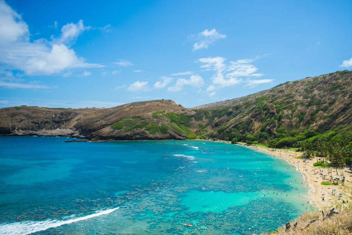 The crescent-shaped turquoise waters of Hanauma Bay seen from above