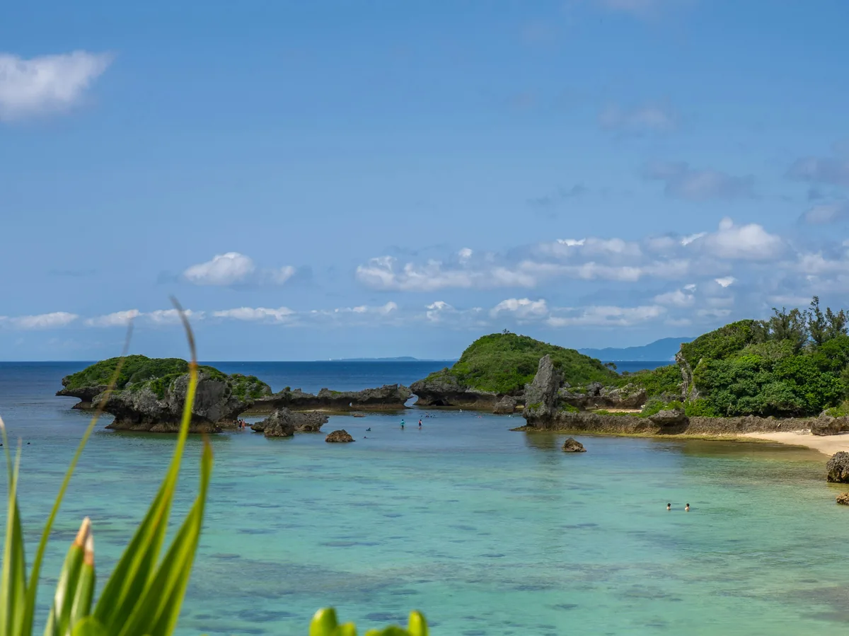 Turquoise water along a sandy beach on Okinawa's coastline, Japan