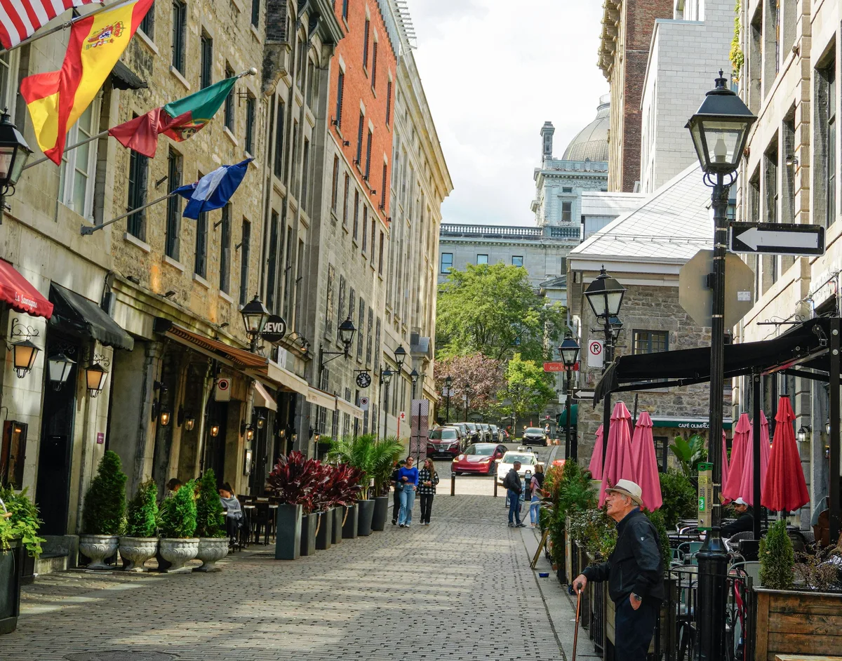 A cobblestone street lined with cafes near Place d'Armes in Old Montreal