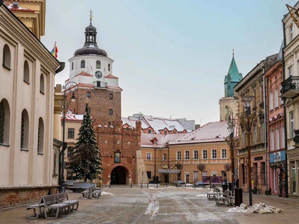 A snow-dusted street in Lublin's historic Old Town, Poland