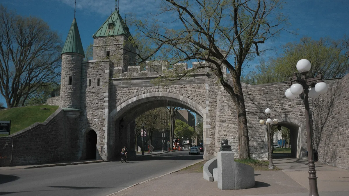 A historic stone fortification wall and gate in an old city