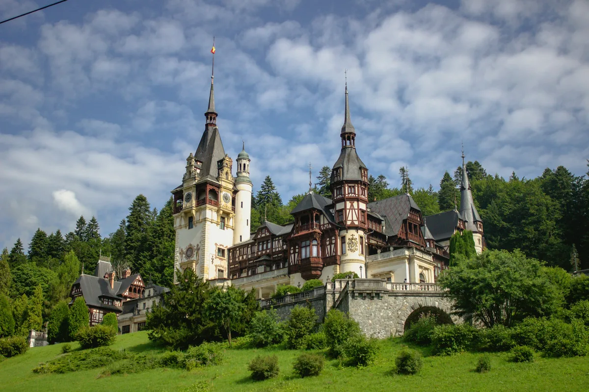 Peleș Castle's turrets among the trees in Sinaia, Romania