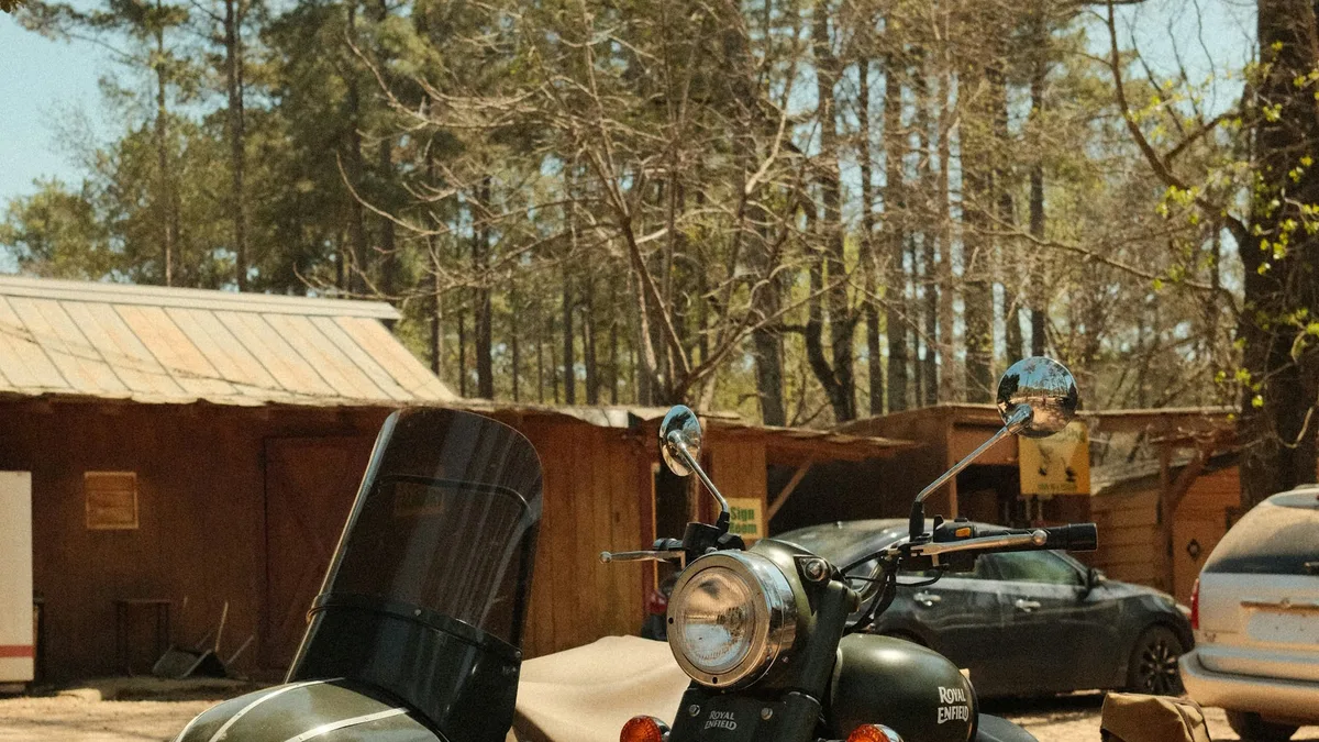A vintage Royal Enfield motorcycle with a sidecar parked outdoors