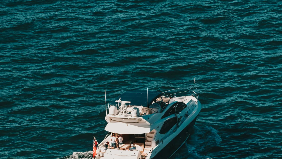 A private motor yacht cruising on open water under a clear sky