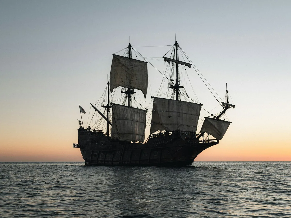 Silhouette of a historic sailing ship on the ocean
