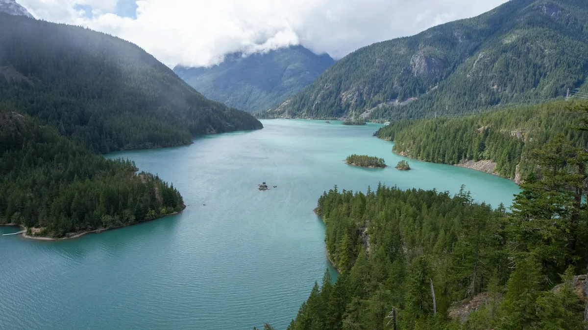 A turquoise alpine lake surrounded by snow-capped mountains