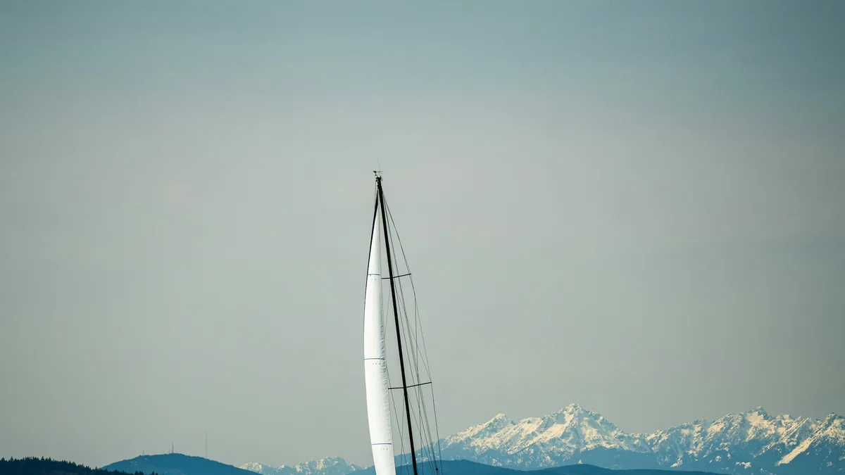A sailboat with its sails up on open water