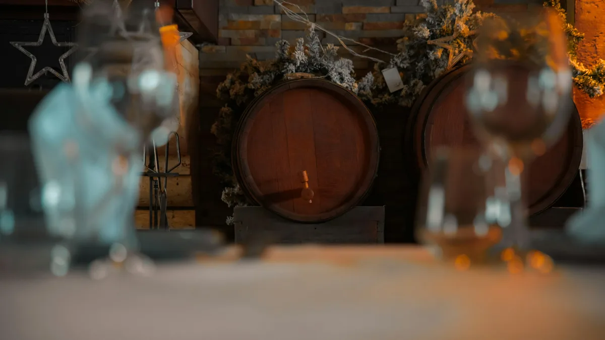 A rustic winery tasting room with wine glasses on a barrel