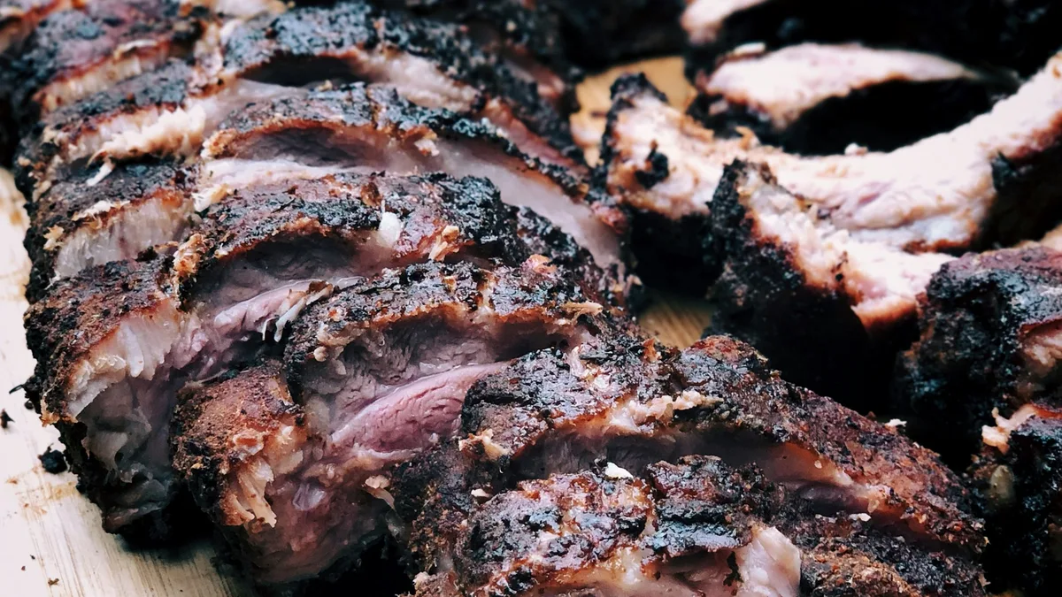 Smoked barbecue ribs and brisket on a wooden board