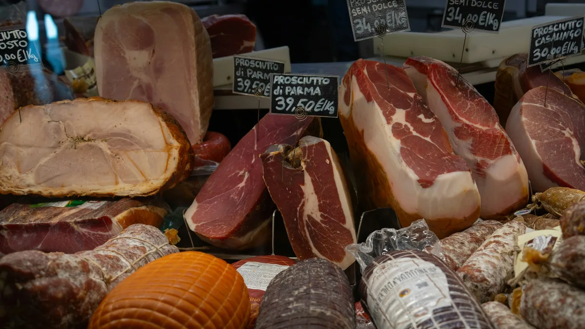 A cozy Italian deli counter with cured meats and cheeses