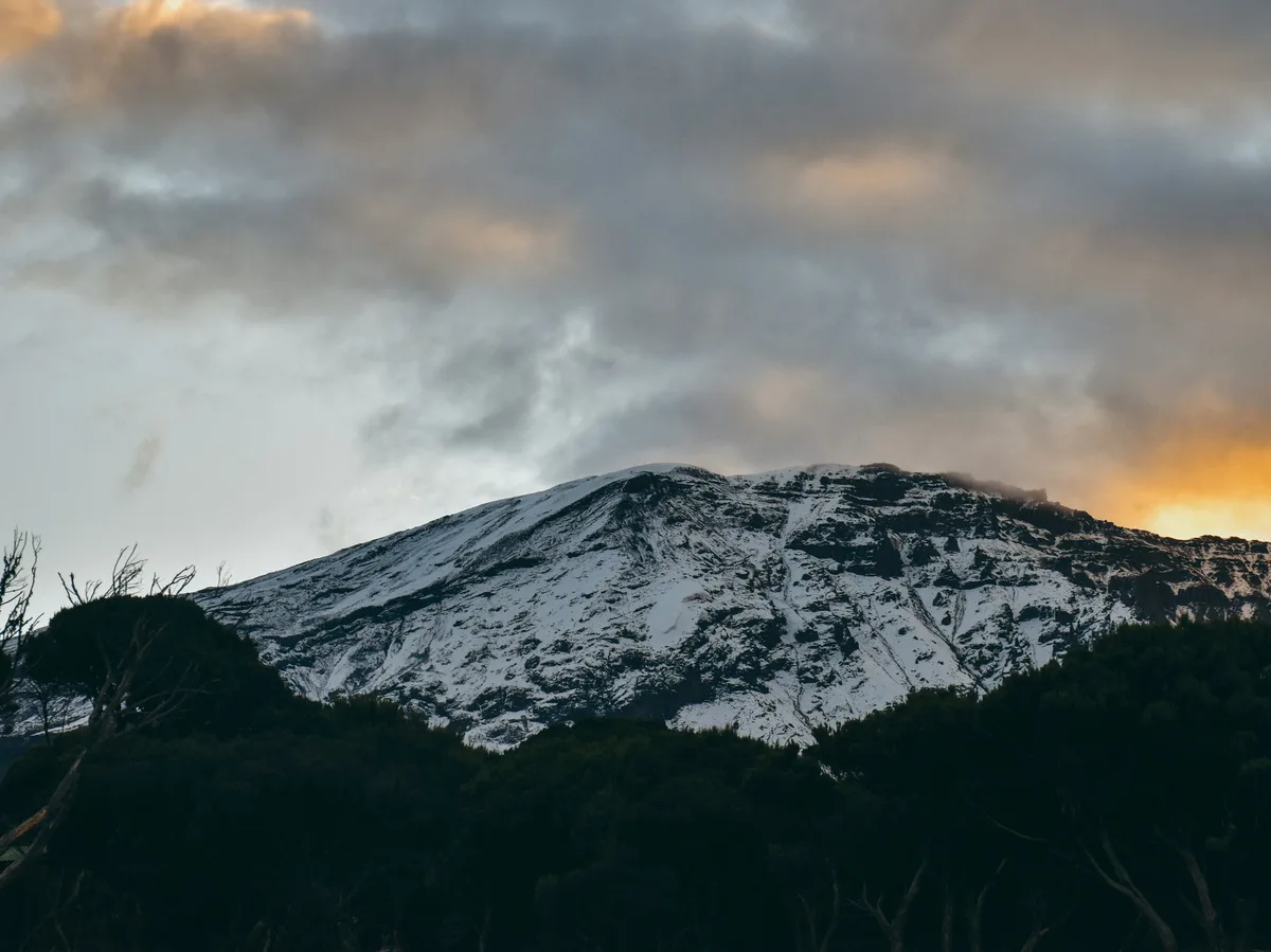 Mount Kilimanjaro's snow-capped summit rising above the Tanzanian plains