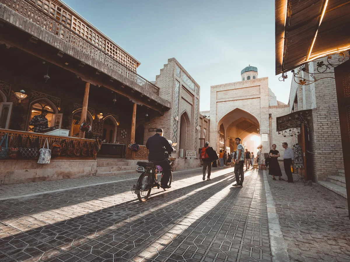 A cyclist riding through the old town streets of Bukhara, Uzbekistan