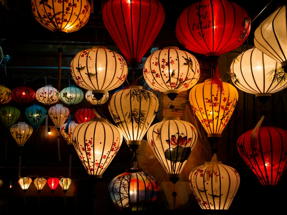 Colorful silk lanterns strung above a street in Hoi An's Ancient Town, Vietnam