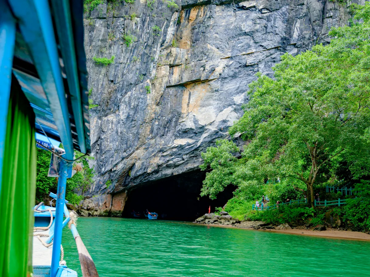 A boat traveling along the river through Phong Nha Cave, Vietnam